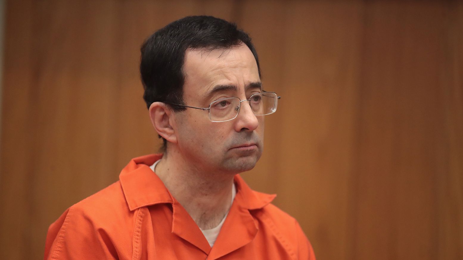Larry Nassar stands as he is sentenced for three counts of criminal sexual assault in Eaton County Circuit Court on February 5, 2018 in Charlotte, Michigan.