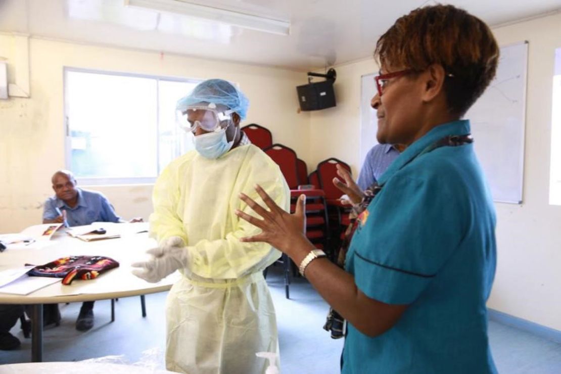 Janlyn Kumbu of PNG's Central Public Health Laboratory trains health workers in Vanimo, West Sepik, on proper PPE procedures.