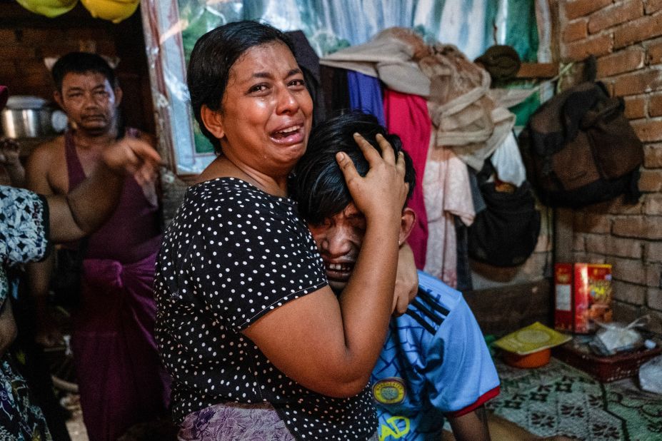 People cry in Yangon after a relative was shot during a crackdown on anti-coup protesters.