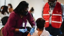 FILE - In this March 17, 2021, file photo, health worker administers a dose of a Pfizer COVID-19 vaccine during a vaccination clinic at the Grand Yesha Ballroom in Philadelphia. (AP Photo/Matt Rourke, File)