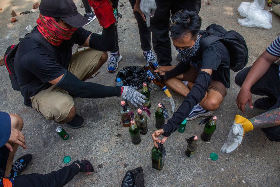 Protesters make incendiary devices during an anti-coup rally in Yangon.