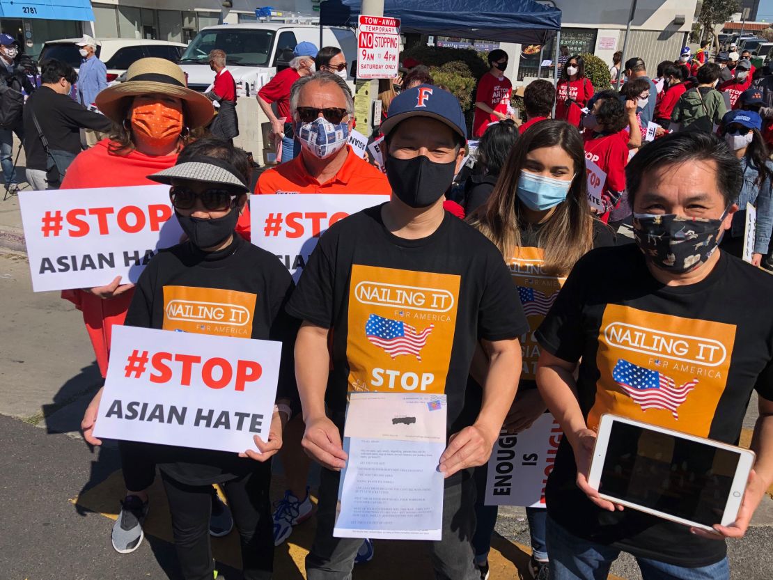 From left, Kien Nguyen, Tam Nguyen and Ted Nguyen, rally to stop anti-Asian violence in Los Angeles on Saturday, March 27, 2021.