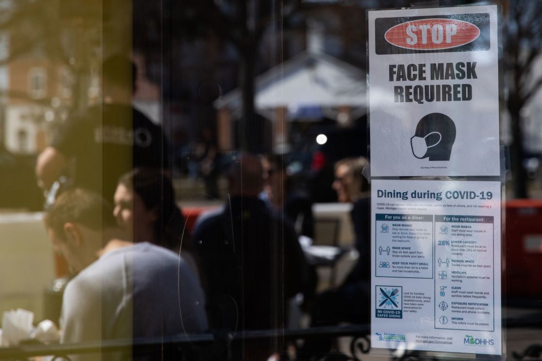 A sign requiring face masks and Covid-19 protocols at a restaurant in Plymouth, Michigan, on Sunday, March 21, 2021