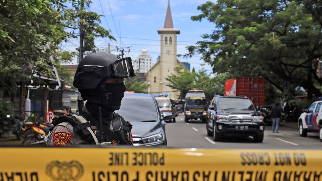 A police officer stands guard near the church in Makassar, South Sulawesi, Indonesia after Sunday's explosion.
