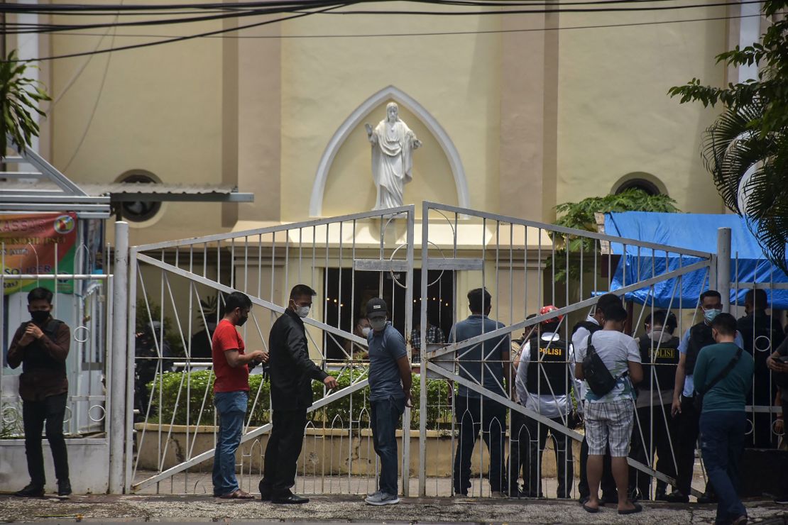 Indonesian police examine the site outside a church after an explosion in Makassar on March 28.