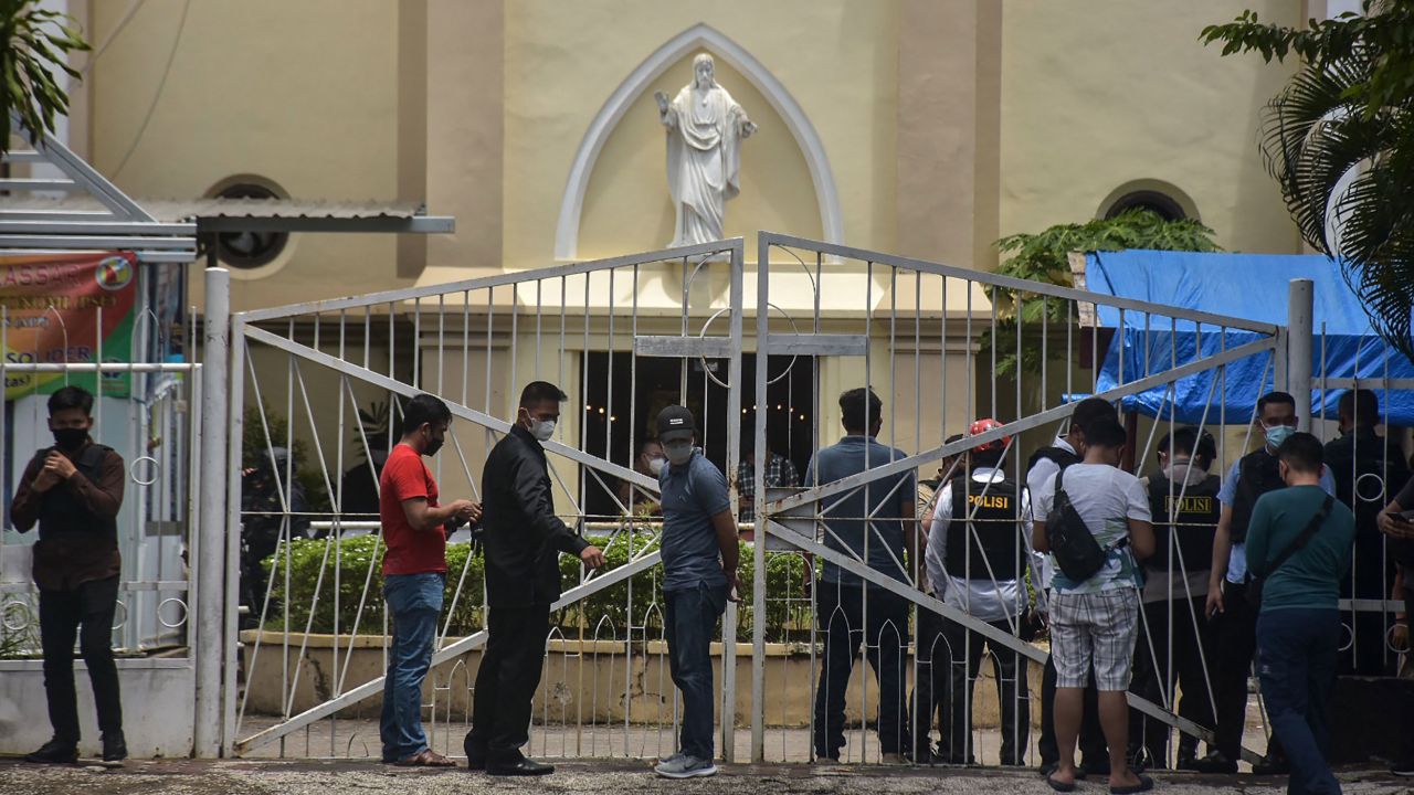 Indonesian police examine the site outside a church after an explosion in Makassar on March 28.