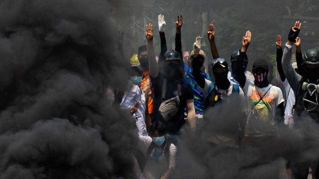 Smoke rises after anti-coup protesters burned tires in Yangon on March 27.