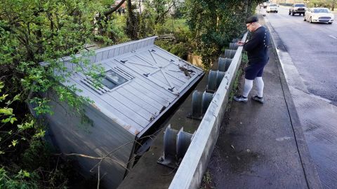 A utility building was carried down a flooded creek in Nashville Sunday.