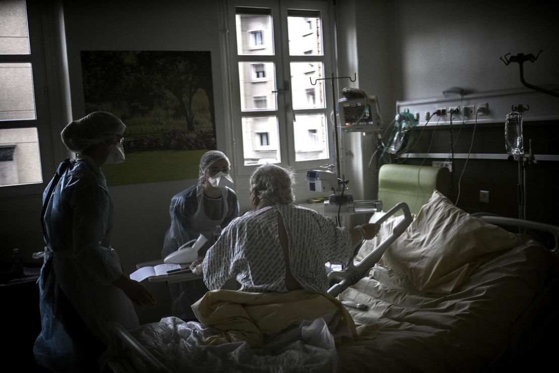 Nurses help a Covid-19 patient at a Paris hospital on March 18.