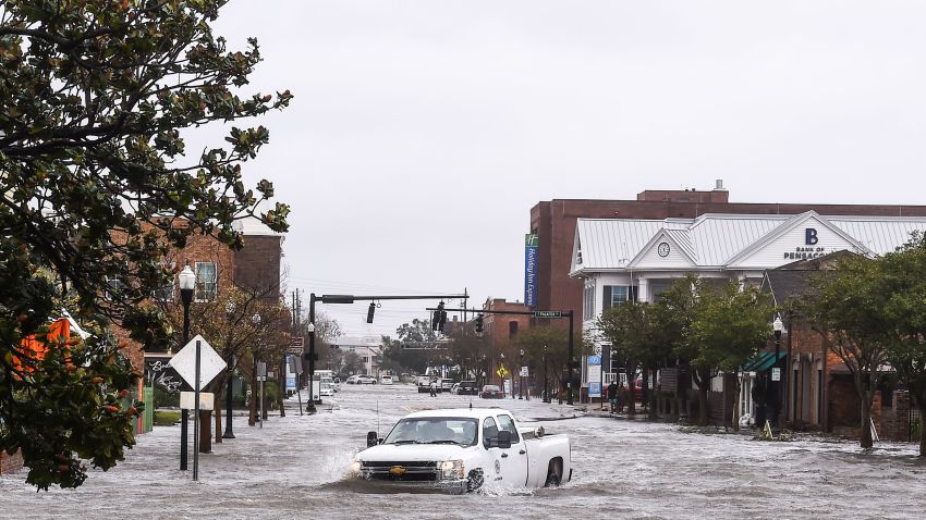 TOPSHOT - A city worker drives through the flooded street during Hurricane Sally in downtown Pensacola, Florida on September 16, 2020. - Hurricane Sally barrelled into the US Gulf Coast early Wednesday, with forecasts of drenching rains that could provoke "historic" and potentially deadly flash floods.The National Hurricane Center (NHC) said the Category 2 storm hit Gulf Shores, Alabama at about 4:45 am (0945 GMT), bringing maximum sustained winds of about 105 miles (165 kilometers) per hour."Historic life-threatening flooding likely along portions of the northern Gulf coast," the Miami-based center had warned late Tuesday, adding the hurricane could dump up to 20 inches (50 centimeters) of rain in some areas. (Photo by CHANDAN KHANNA / AFP) (Photo by CHANDAN KHANNA/AFP via Getty Images)