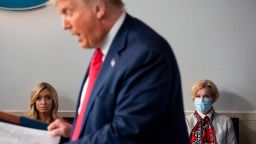 White House Press Secretary Kayleigh McEnany (left), sits next to Response coordinator for White House Coronavirus Task Force Deborah Birx, as they listen to US President Donald Trump deliver a news conference in the Brady Briefing Room of the White House in Washington, DC, on July 23, 2020. 