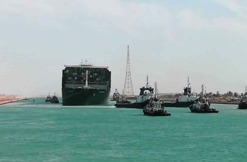 The Ever Given is accompanied by tugboats as it moves through the canal on Monday.