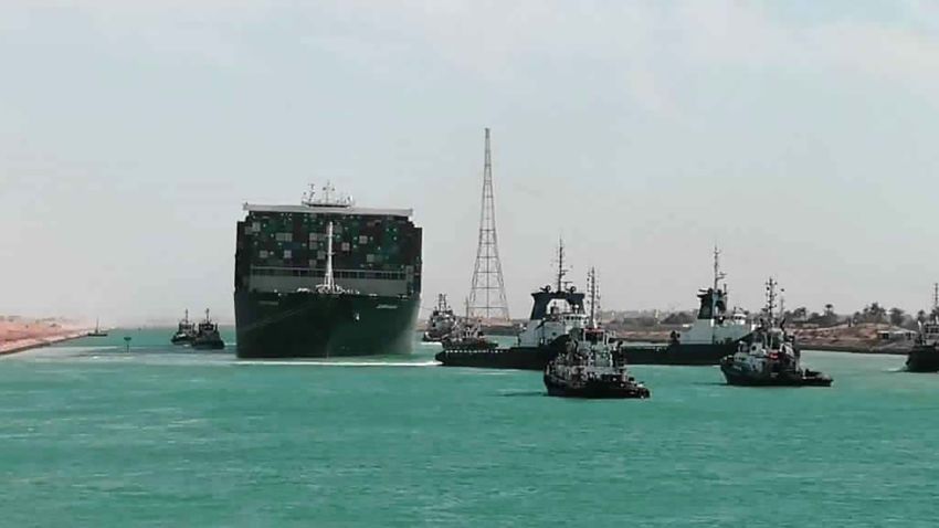 In this photo released by Suez Canal Authority, the Ever Given, a Panama-flagged cargo ship is accompanied by Suez Canal tugboats as it moves in the Suez Canal, Egypt, Monday, March 29, 2021. Salvage teams on Monday set free a colossal container ship that has halted global trade through the Suez Canal, bringing an end to a crisis that for nearly a week had clogged one of the world's most vital maritime arteries. (Suez Canal Authority via AP)