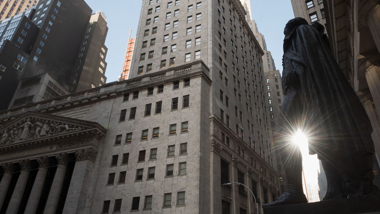 View of the New York Stock Exchange (NYSE) and a  statue of George Washington at Wall Street on March 23, 2021 in New York City. - Wall Street stocks were under pressure early ahead of congressional testimony from Federal Reserve Chief Jerome Powell as US Treasury bond yields continued to retreat. (Photo by Angela Weiss/AFP/Getty Images)