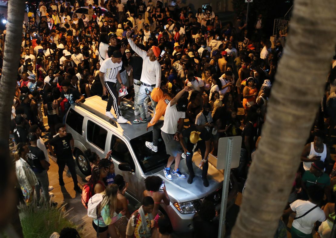 People gathered as an 8 p.m. curfew went into effect on March 21 in Miami Beach, Florida. College students flooded the area for spring break, prompting officials to impose a curfew due to the pandemic.