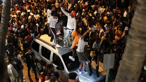 People gathered as an 8 p.m. curfew went into effect on March 21 in Miami Beach, Florida. College students flooded the area for spring break, prompting officials to impose a curfew due to the pandemic.