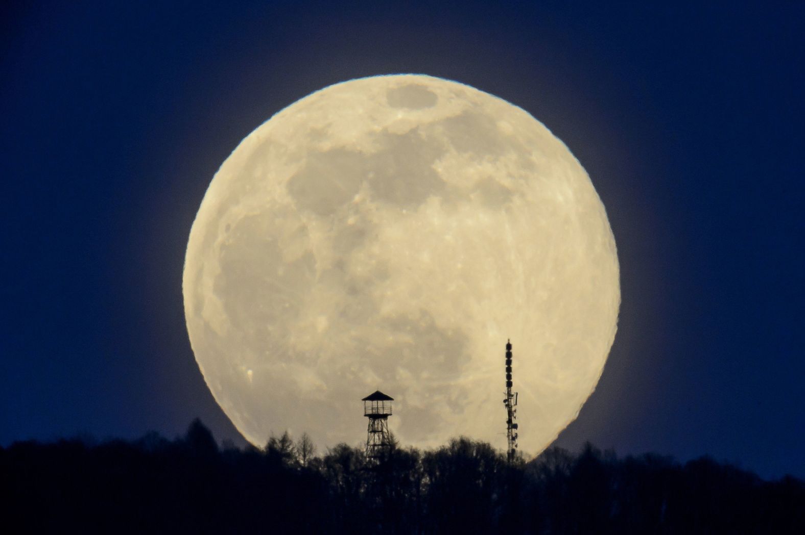 The moon is seen above the Karancs Hills in Karancskeszi, Hungary, on Sunday, March 28.