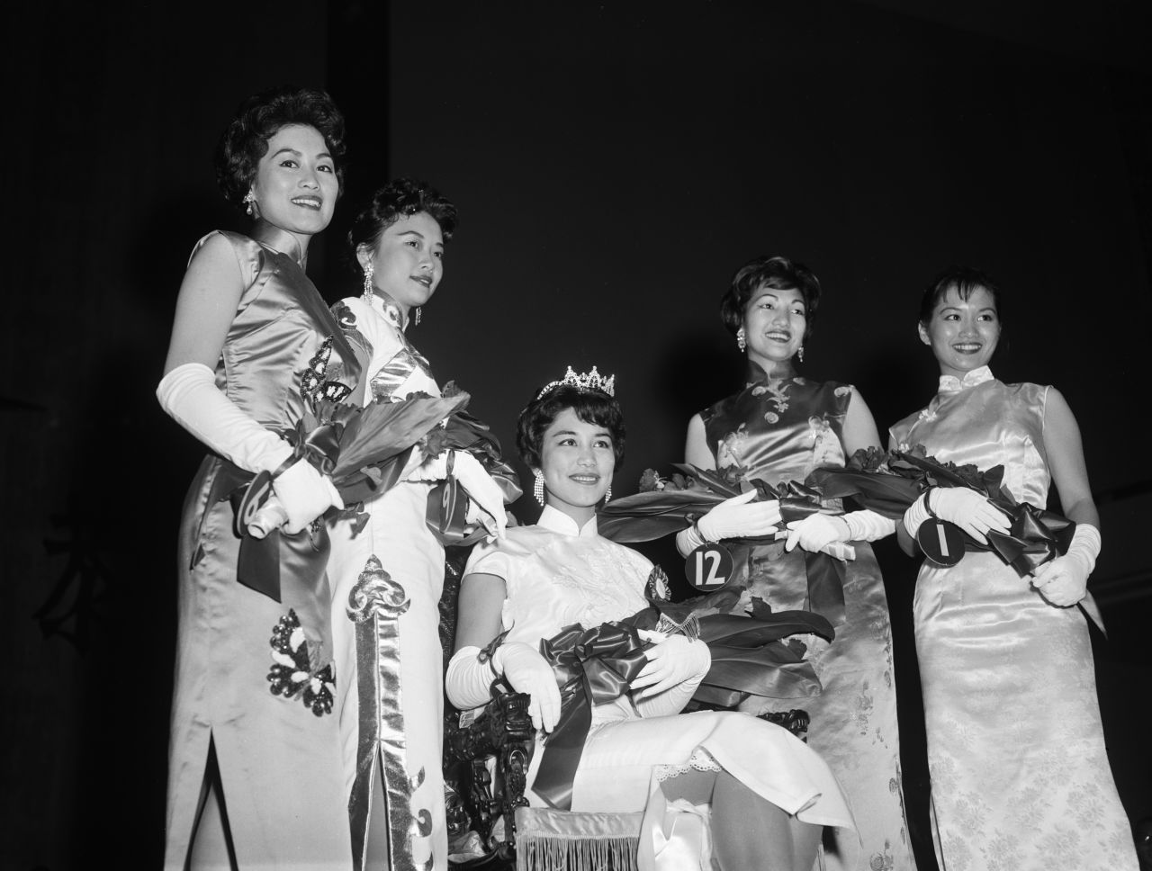Four runner-ups stand around Carol Ng, winner of the Miss Chinatown USA pageant of 1960.