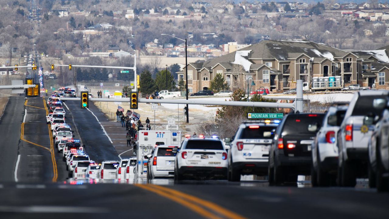 Police vehicles head to Flatirons Community Church for service of Boulder Officer Eric Talley. 