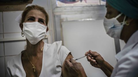 A nurse inoculates a healthcare worker with a dose of the Soberana-02 COVID-19 vaccine, in Havana, Cuba, March 24.