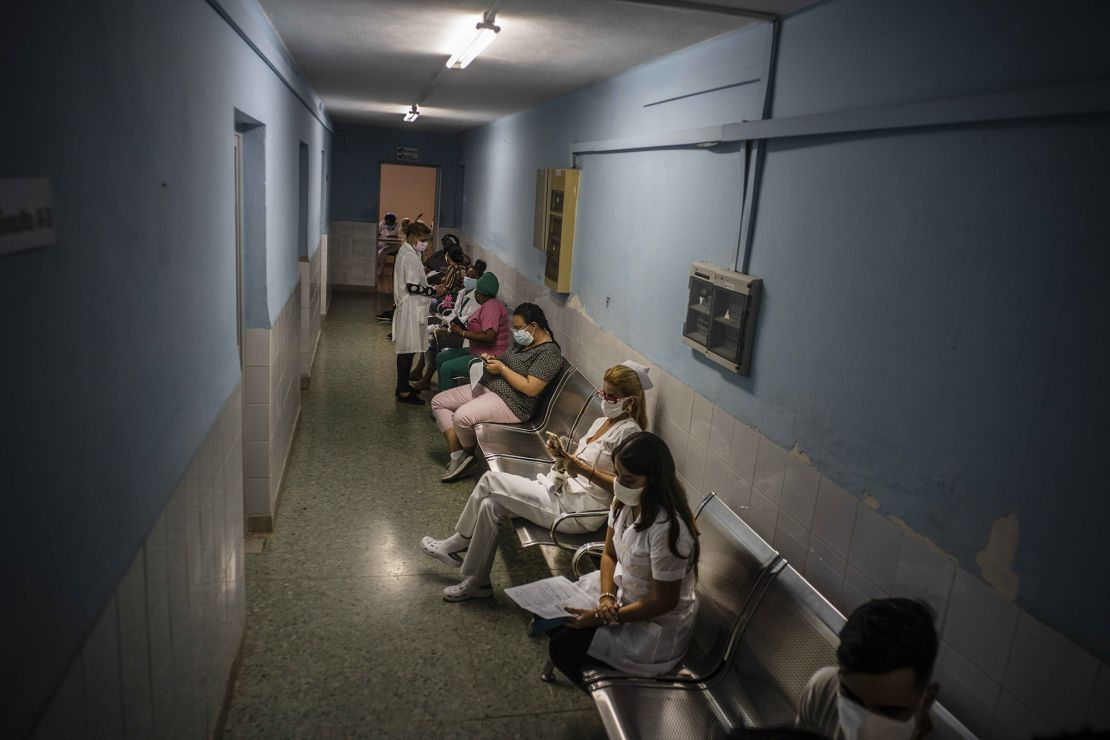 Healthcare workers sit in hallway as they wait to be injected with a dose of the Soberana-02 Covid-19 vaccine, in Havana, Cuba, March 24.
