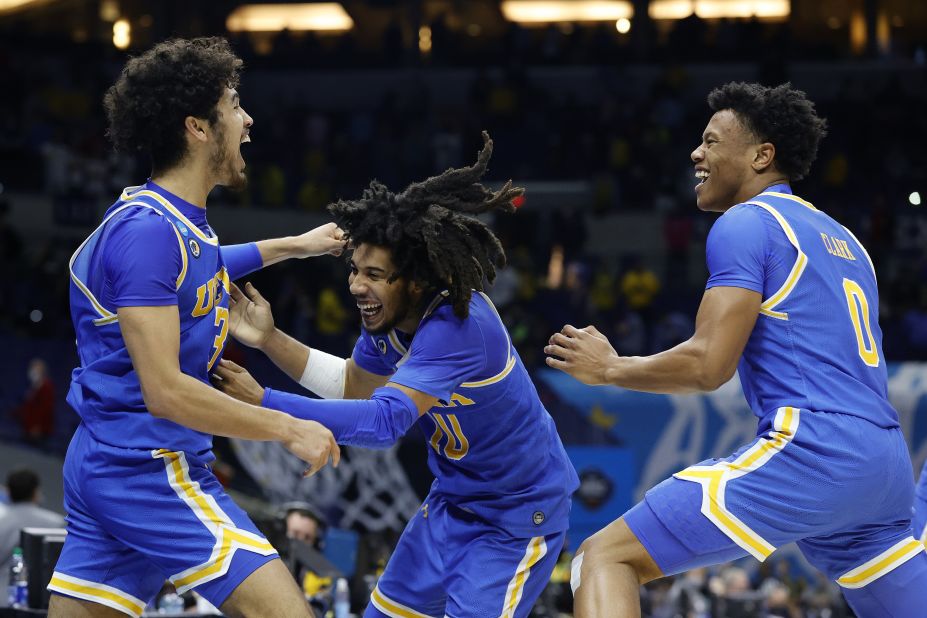From left, UCLA's Johnny Juzang, Tyger Campbell and Jaylen Clark celebrate on Tuesday after the Bruins defeated Michigan 51-49 to make the Final Four. UCLA, an 11-seed, started in the First Four and then rattled off five straight tournament wins.