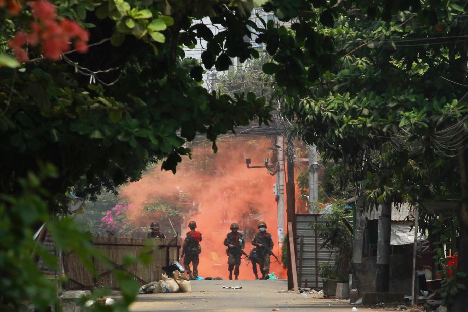 Soldiers walk toward anti-coup protesters during a demonstration in Yangon on March 30.