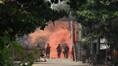 Soldiers walk towards anti-coup protesters during a demonstration in Yangon, Myanmar on Tuesday March 30, 2021. Thailand's Prime Minister Prayuth Chan-ocha denied Tuesday that his country's security forces have sent villagers back to Myanmar who fled from military airstrikes and said his government is ready to shelter anyone who is escaping fighting. (AP Photo)