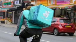 Mandatory Credit: Photo by Dinendra Haria/SOPA Images/Shutterstock (11790142a)A Deliveroo cyclist riding with a package in London.Brands in London, UK