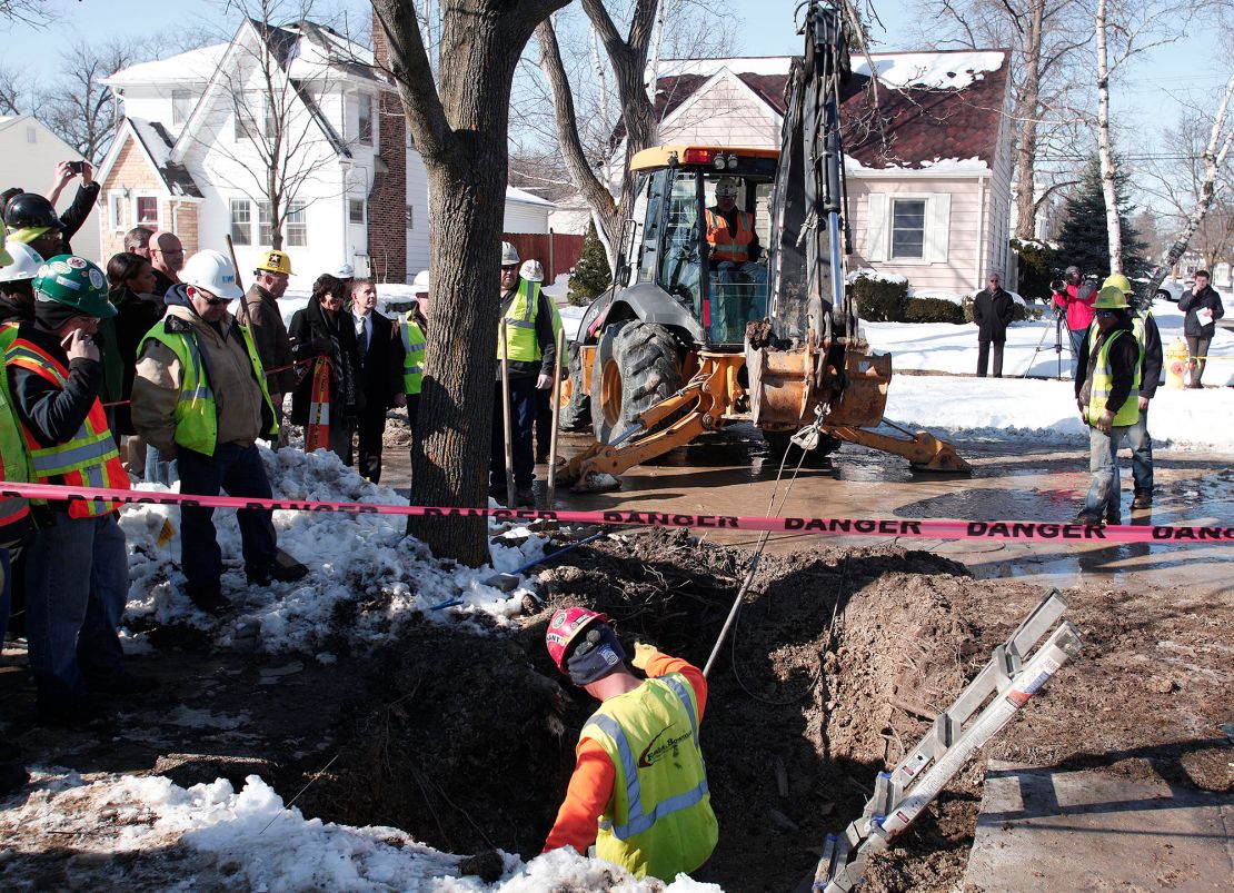 Workers in Flint, Michigan, prepare to replace a lead water service line pipe in 2016. Biden's plan aims to replace all of the nation's lead pipes and services lines.