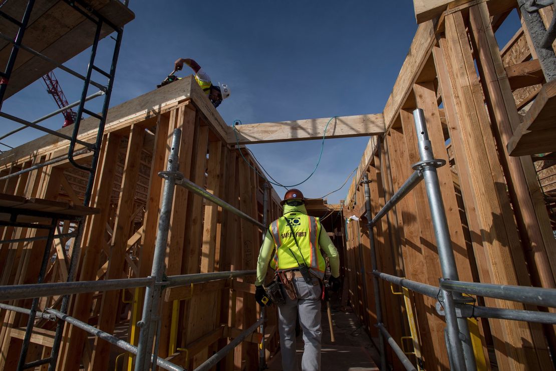 A construction worker walks through an affordable housing project in Oakland, California, in 2019. Biden's plan would invest in affordable housing.