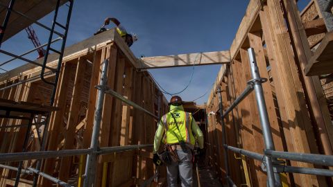 A construction worker walks through an affordable housing project in Oakland, California, in 2019. Biden's plan would invest in affordable housing.