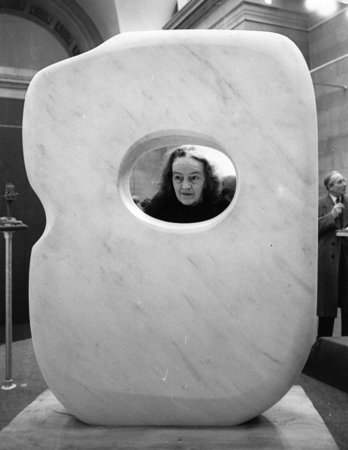 Artist Barbara Hepworth posing through her own work "Pierced Form 1963,"' at the Tate Gallery, London. 