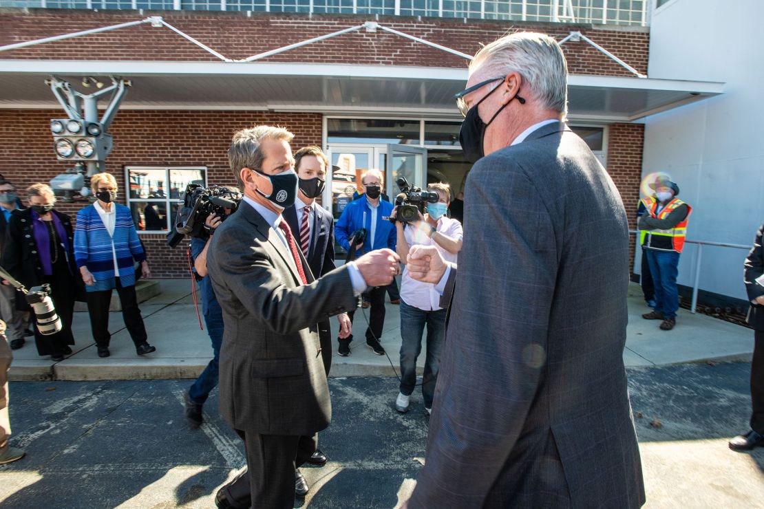 Georgia Gov. Brian Kemp and Delta CEO Ed Bastian, right, in happier times when Kemp was touring the Delta Air Lines vaccine facility on February 24. Kemp and Bastian clashed Wednesday over the recently passed Georgia voting legislation.