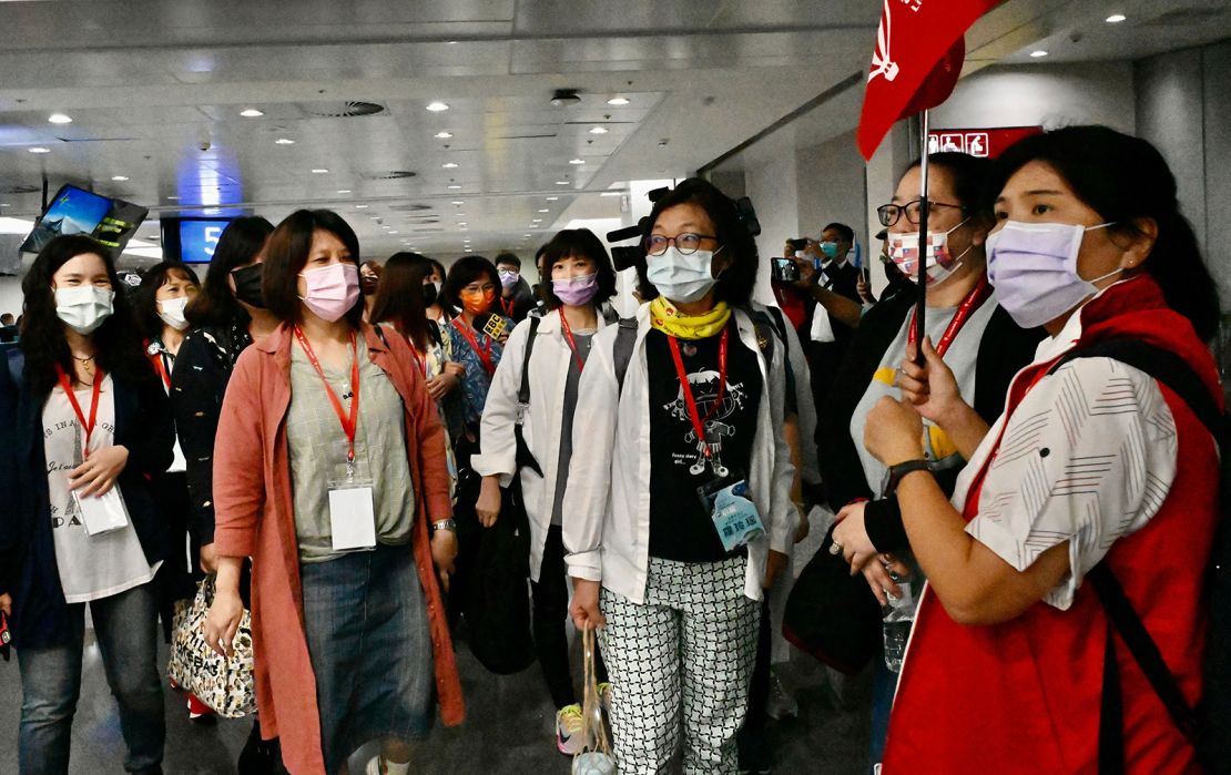 Travelers on the inaugural Taiwan-to-Palau flight gather at Taipei's airport ahead of their trip.