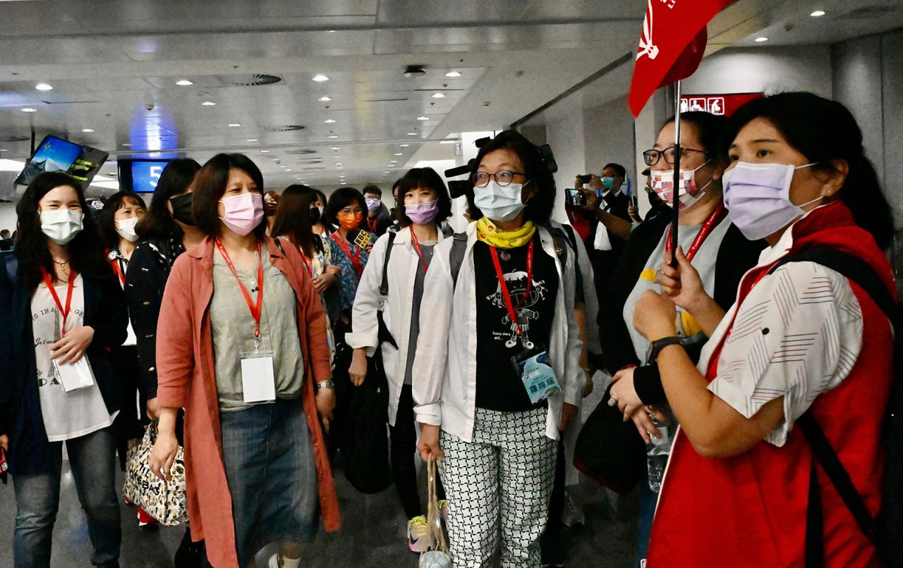 Travelers on the inaugural Taiwan-to-Palau flight gather at Taipei's airport ahead of their trip.