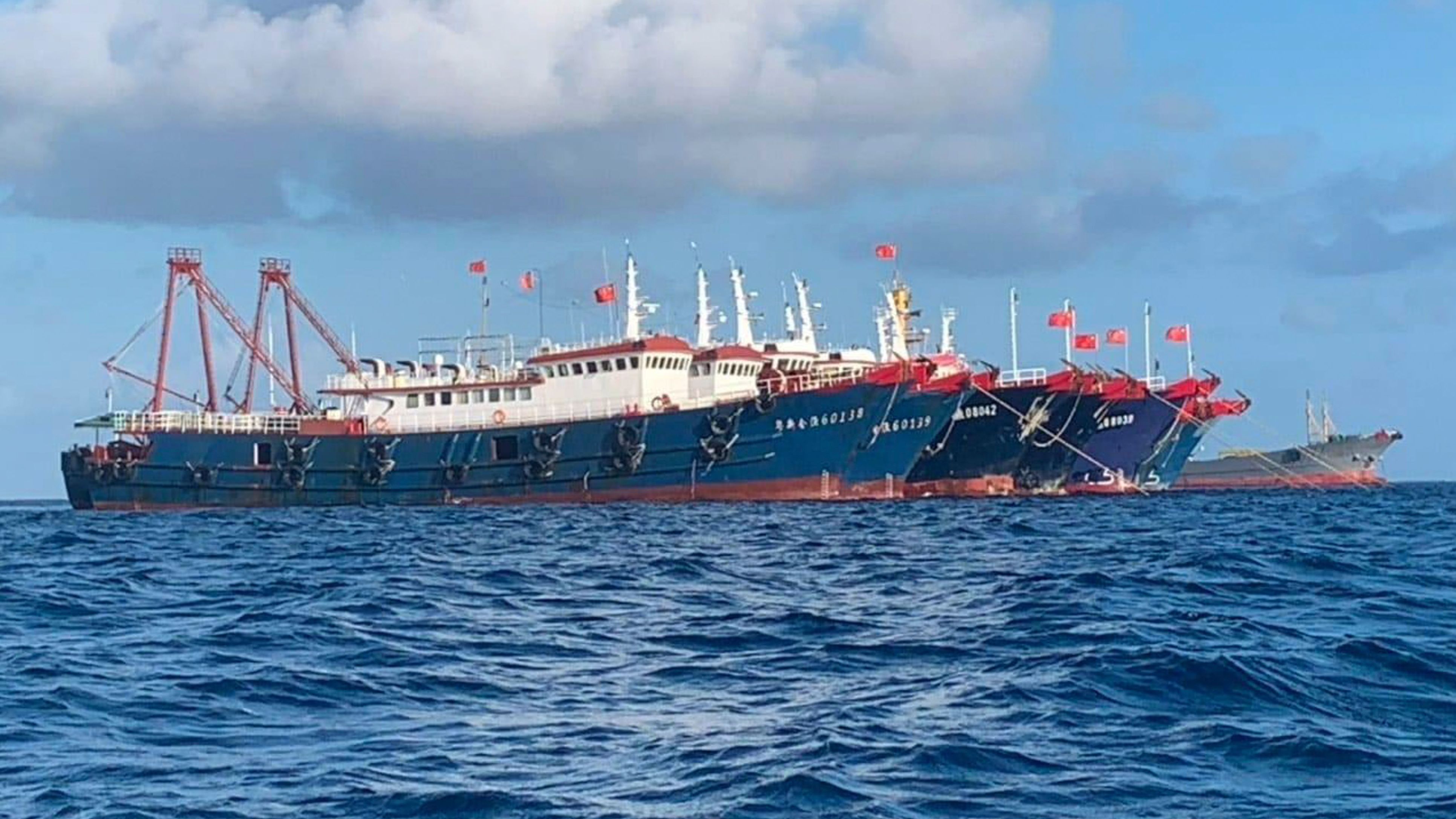 In this photo provided by the National Task Force-West Philippine Sea, Chinese vessels are moored at Whitsun Reef, South China Sea on March 27, 2021.