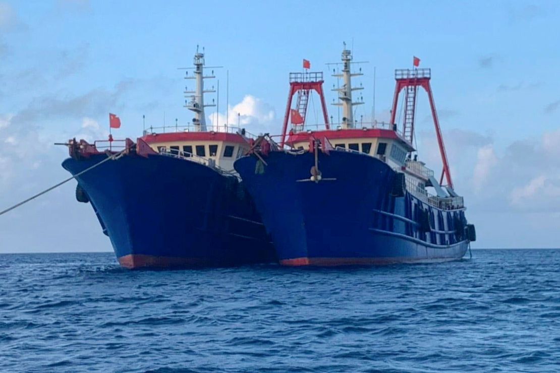 In this photo provided by the National Task Force-West Philippine Sea, Chinese vessels are moored at Whitsun Reef, South China Sea, on March 27, 2021. 