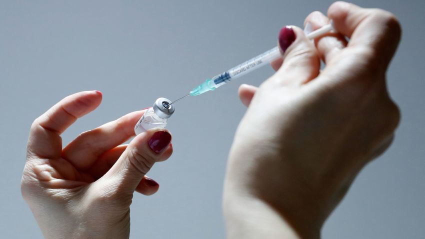 A medical worker prepares to administer a dose of the AstraZeneca vaccine in Belgrade, Serbia, Tuesday, March 23, 2021. American federal health officials say results from a U.S. trial of AstraZeneca's COVID-19 vaccine may have included "outdated information" and that could mean the company provided an incomplete view of efficacy data. (AP Photo/Darko Vojinovic)