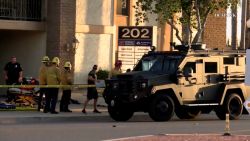 A police truck is parked outside the scene of a mass shooting in Orange, California.