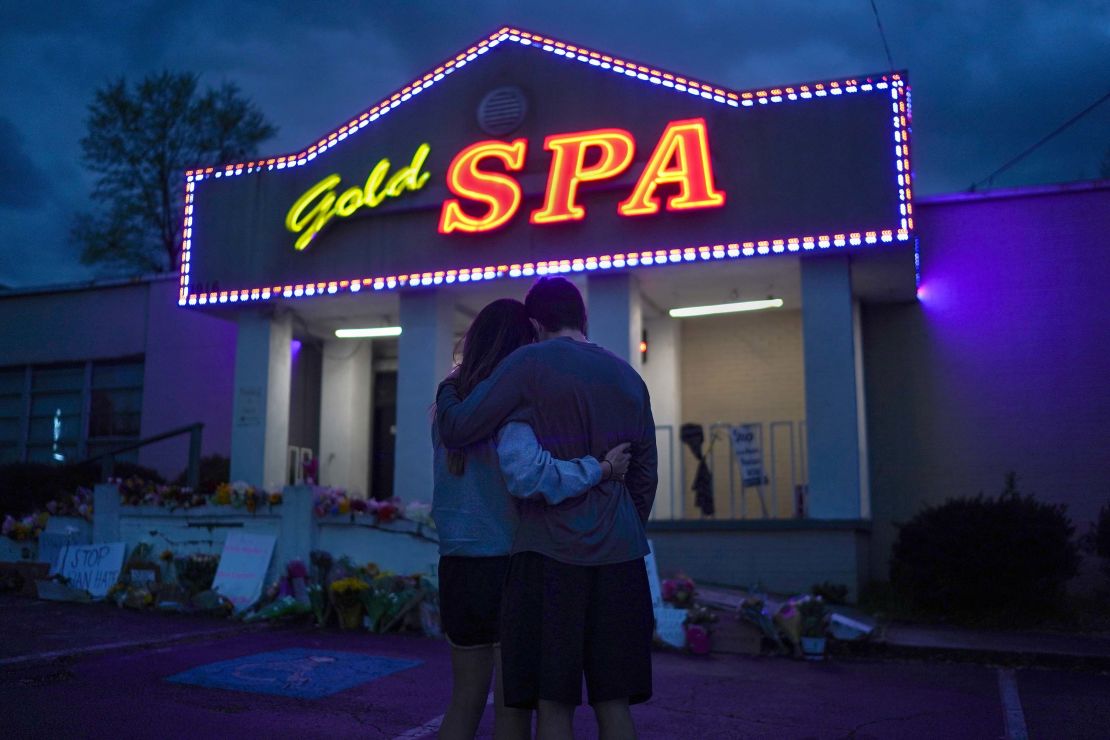 Cynthia Shi and her boyfriend, Graham Bloomsmith, embrace outside the Gold Massage Spa in Atlanta on Thursday, March 18.