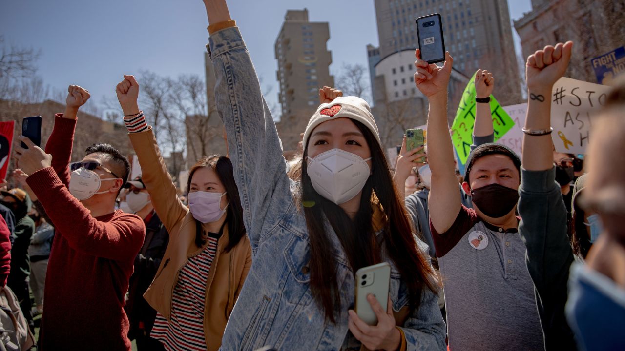 Demonstrators raise their fists during a rally in New York on March 21. 