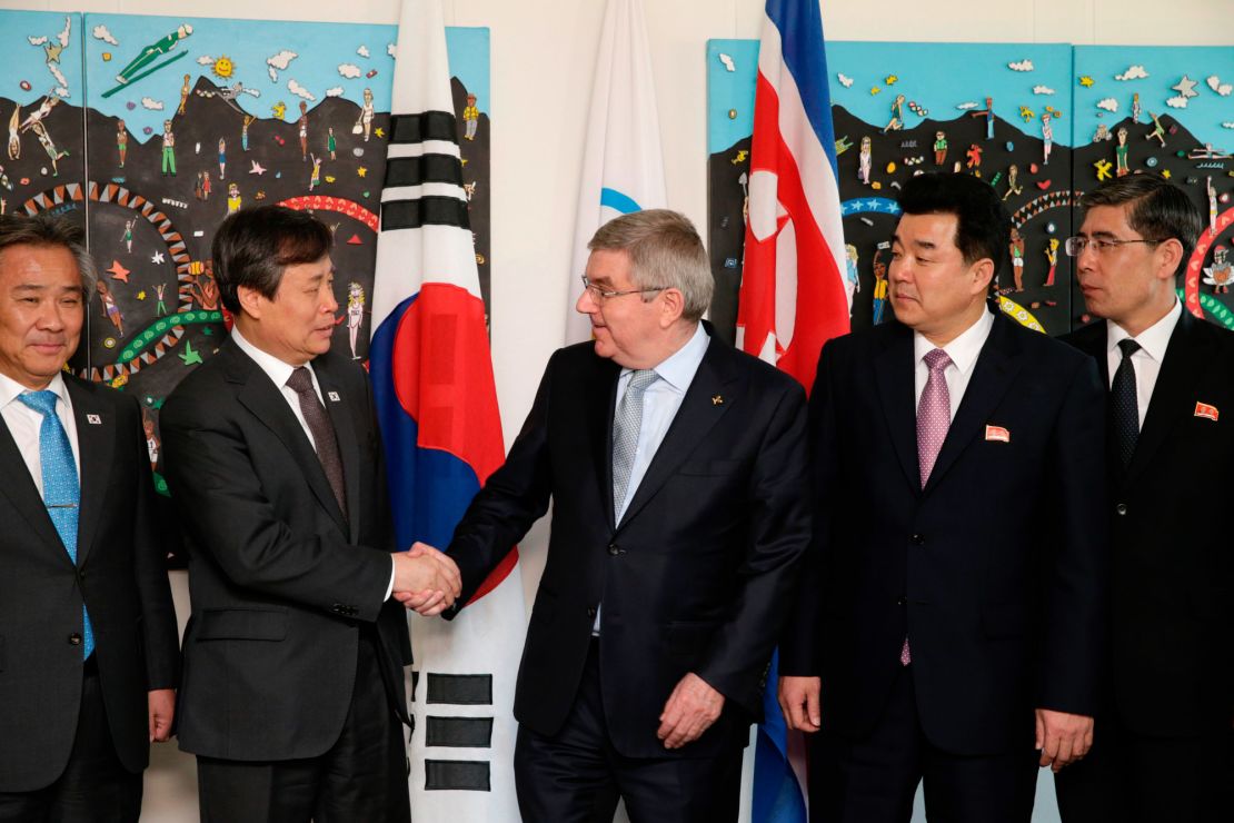 IOC president Thomas Bach (right)  shakes hands with South Korean Sports Minister Do Jong-hwan (second left) next to North Korea's Olympic Committee President and sports minister Kim Il Guk (second right).