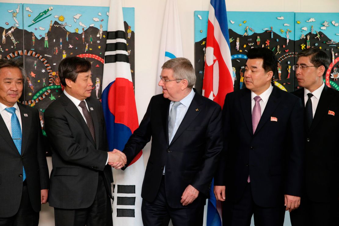 IOC president Thomas Bach (right) shakes hands with South Korean Sports Minister Do Jong-hwan (second left) next to North Korea's Olympic Committee President and sports minister Kim Il Guk (second right).