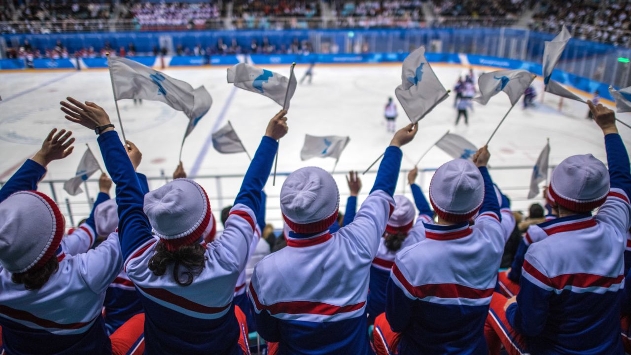 North Korean cheerleaders wave unified Korean flags as they cheer during the Women's Ice Hockey Preliminary Round Group B game between Korea and Japan on day five of the PyeongChang 2018 Winter Olympics.