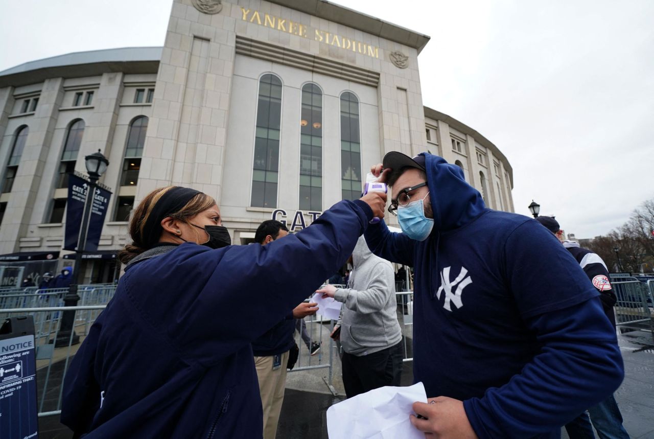 A Yankees fan has his temperature checked before entering the stadium on Thursday.