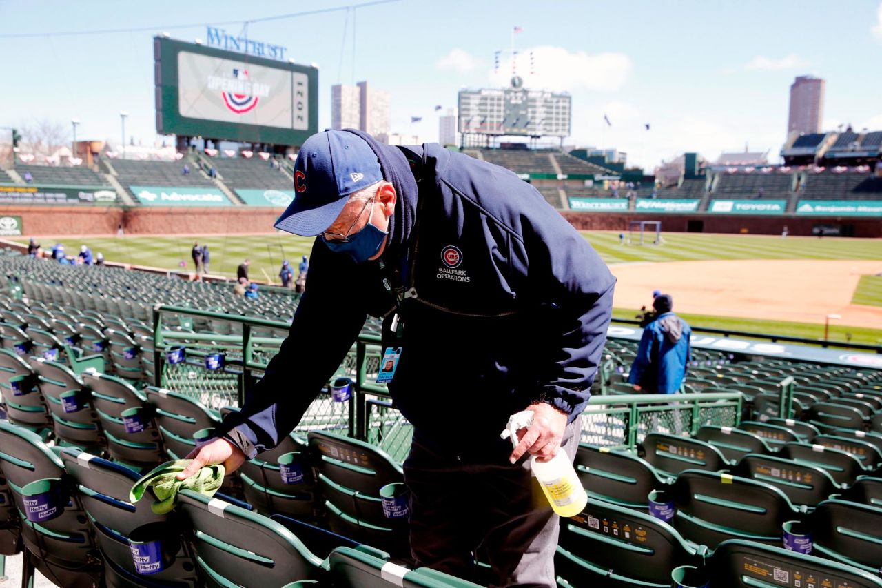 An usher cleans the seats before the Chicago Cubs hosted Pittsburgh at Wrigley Field.
