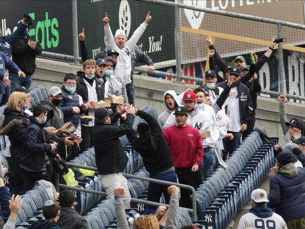 Fans catch a home run hit by Yankees slugger Gary Sanchez.