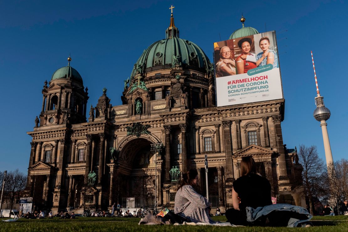 A vaccine campaign poster hangs at Berlin Cathedral.