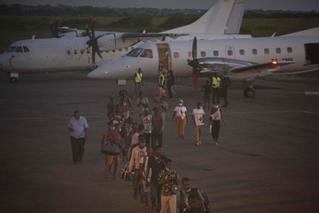 People evacuated from Palma arrive on an humanitarian flight at the airport in Pemba on March 31.